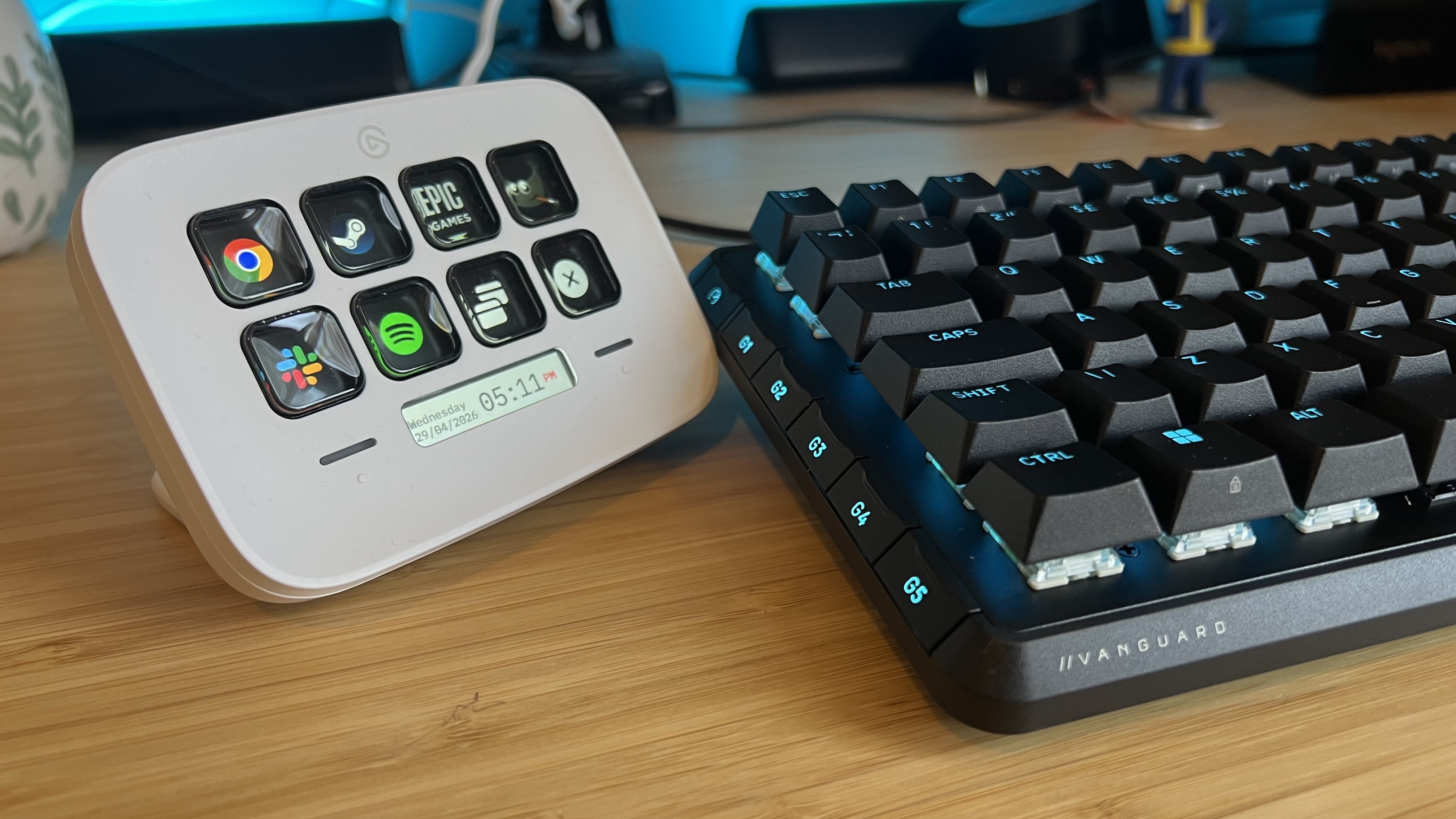 Stream Deck Neo on the left side of a Corsair Vanguard Pro 96 gaming keyboard on a wooden desk