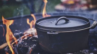 A dutch oven in a campfire