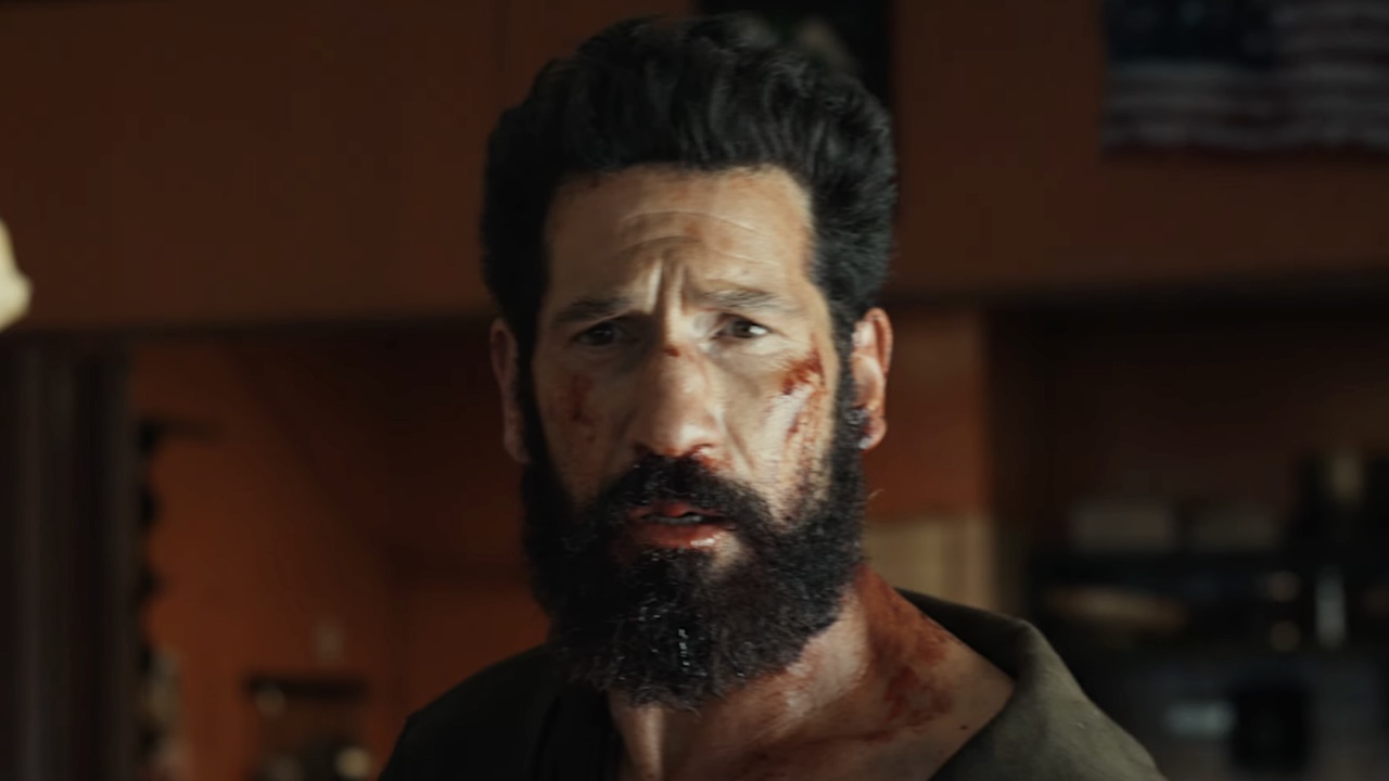 Frank Castle with blood on his cheek and neck in The Punisher: One Last Kill