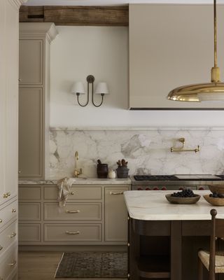a beige kitchen with a matching cooker hood