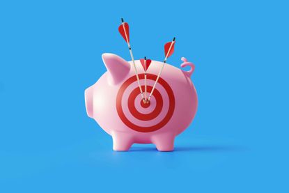 photo of a piggy bank with a target on its side and arrows 