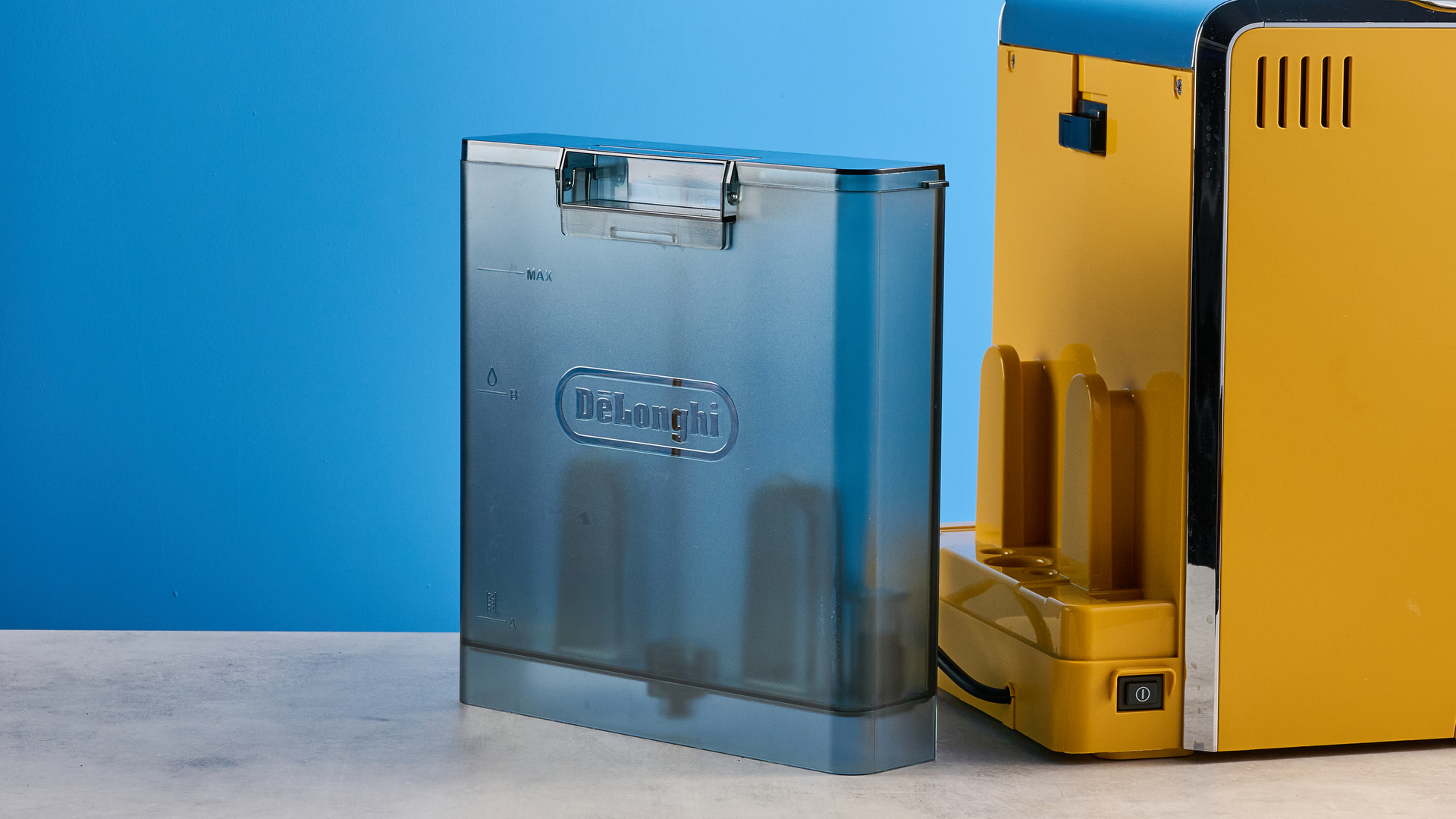 the de&#039;longhi la specialista arte evo special edition truestart edition, with yellow body, showing the espresso machine attachments like tamper, tamping collar, grinder, and control buttons