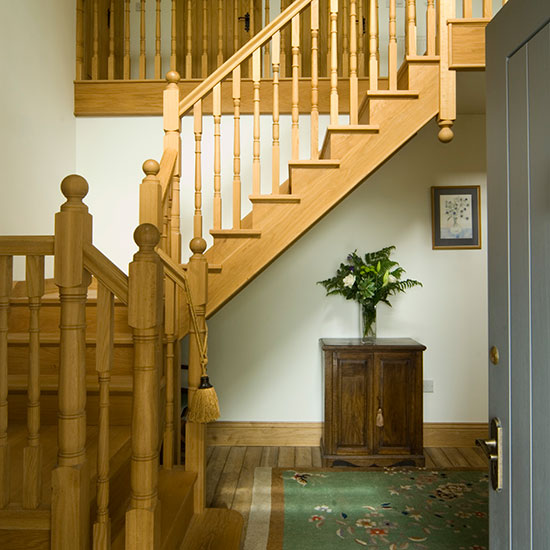 hallway with stairway and cabinet with flower vase