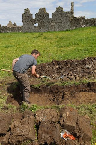 An archeologist digs through the rocky field near Dunluce Castle. The town founded by the MacDonnells in 1608 thrived until 1642, when it burnt down after a conflict. The town never recovered, and people abandoned it in the 1680s, according to researchers.