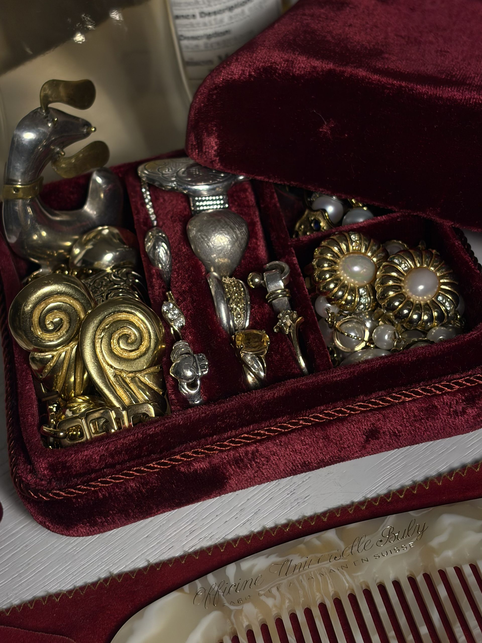 Velvet Kinn jewelry box containing Ysso Ion Earrings, vintage Christian Dior earrings, rings, and a brooch