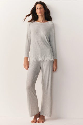 woman wearing grey long sleeved pyjama set with lace detail