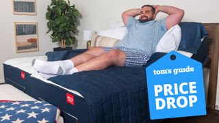 A man in a blue t-shirt relaxes on the Big Fig hybrid mattress