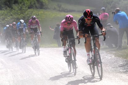 Filippo Ganna leading Egan Bernal on the gravel at the Giro d'Italia 2021