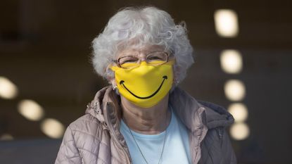 BARRY, WALES - OCTOBER 01: A woman smiles while wearing a novelty face mask in a shop on October 1, 2020 in Barry, Wales. Six more people have died in Wales after testing positive for Covid-19, the most reported in a single day since July 2. Public Health Wales (PHW) also confirmed there were 398 new lab-confirmed positive cases of coronavirus for Thursday, October 1. The highest figure so far during the second wave. More cases were only reported once before on April 10. (Photo by Matthew Horwood/Getty Images)