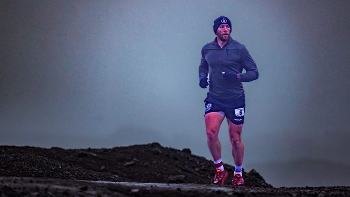 Unidentified man running at the Antarctica Marathon / Antarctica Marathon 2024 official marketing image 