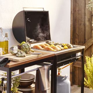 BBQ and trolley in outdoor kitchen