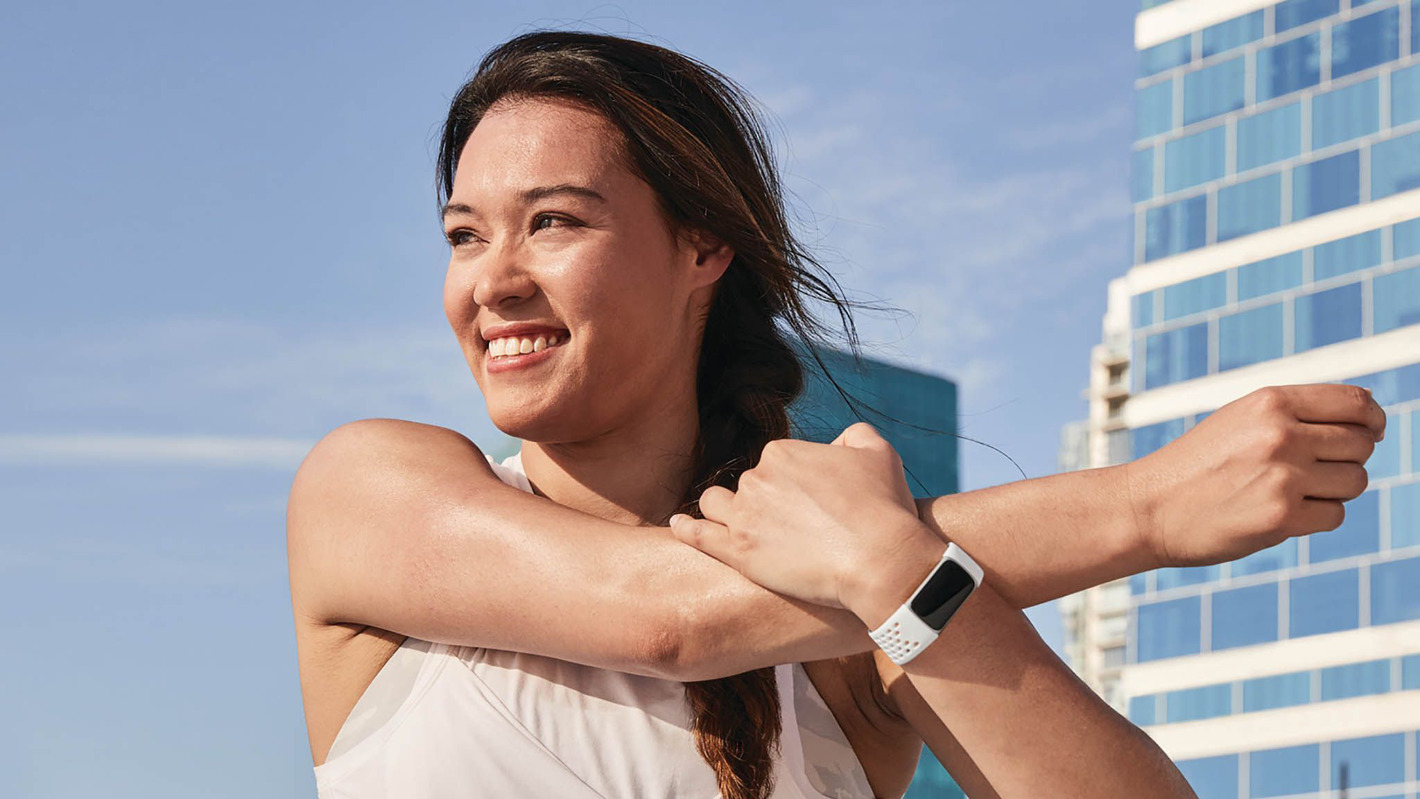 Person stretching wearing Fitbit Charge 5