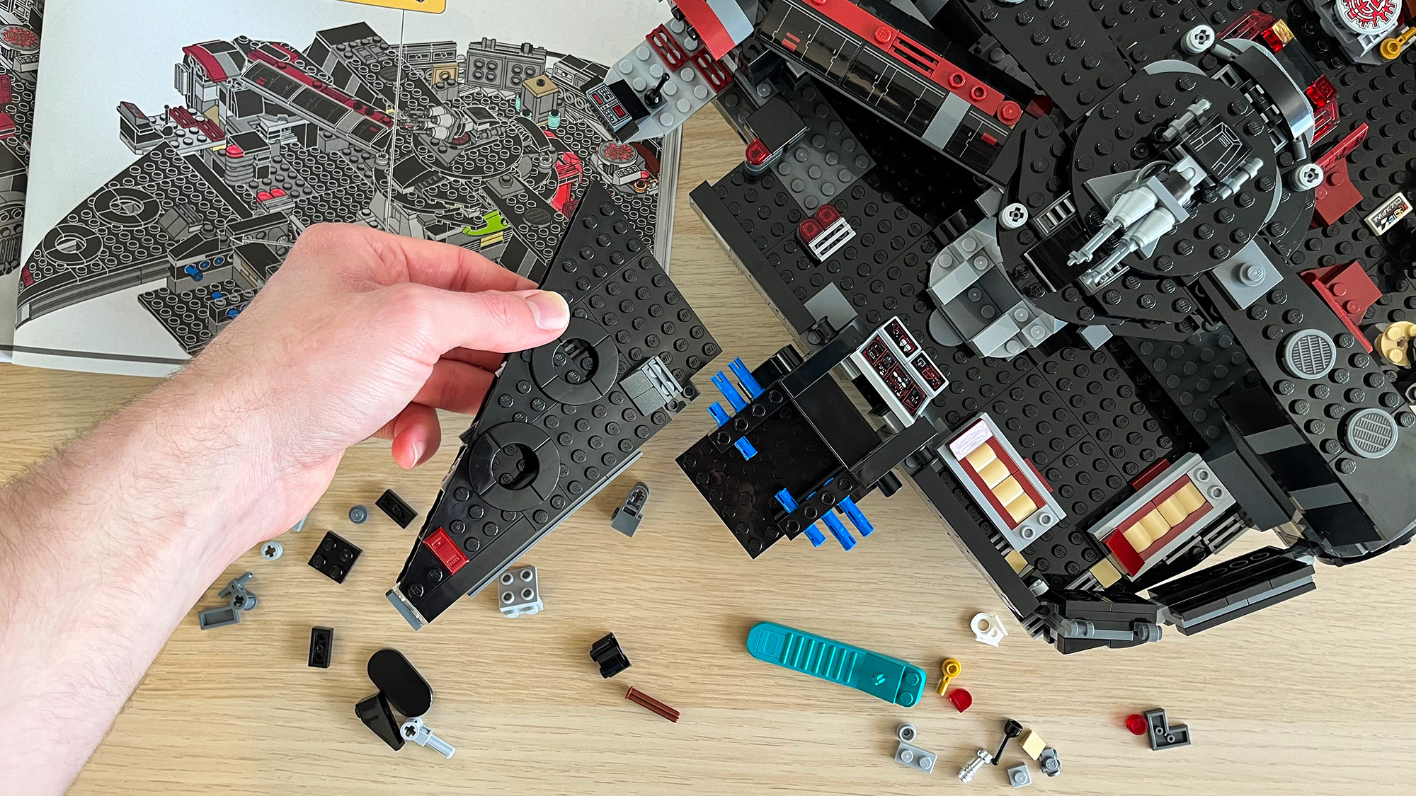 Hand putting together the Lego Star Wars The Dark Falcon (75389) 