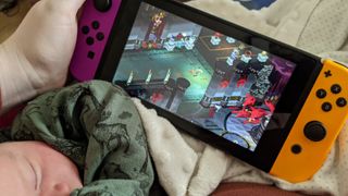 Playing Hades on Nintendo Switch while newborn sleeps