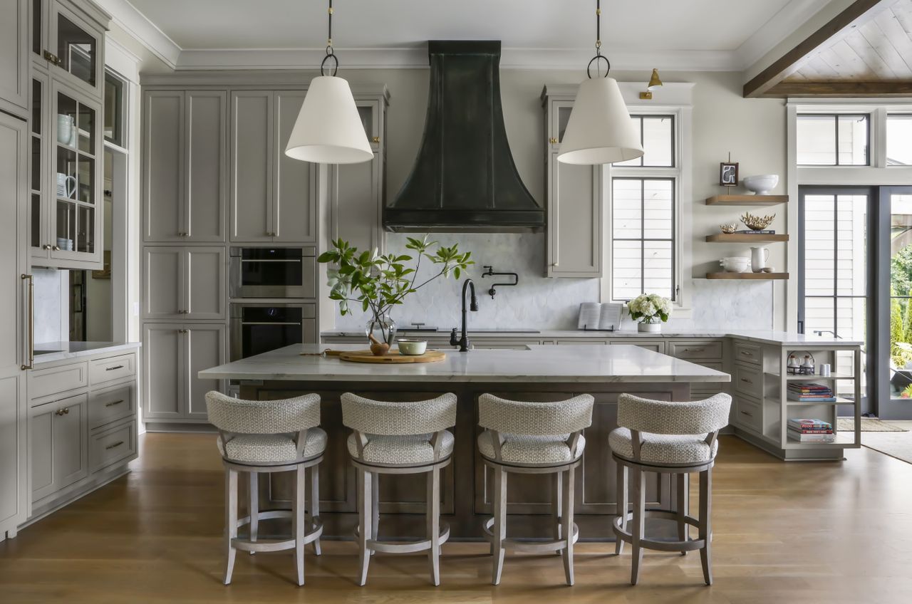 how to make your kitchen island look more expensive; grey kitchen with built-in appliances by Brad Ramsey