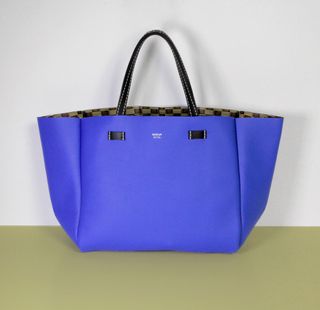 Blue leather handbag with black straps