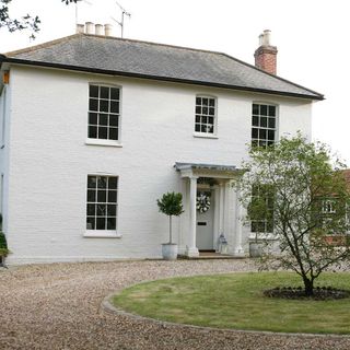 house with sash window and trees