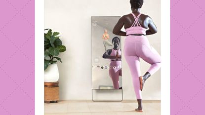 Woman in yoga gear working out with the Lululemon Studio Mirror