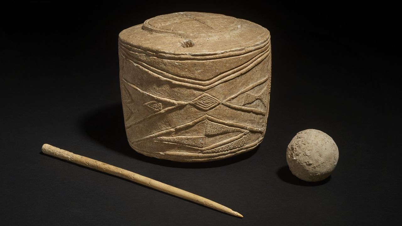 The chalk sculpture, bone pin and ball found with the child burials. They date back about 5,000 years.
