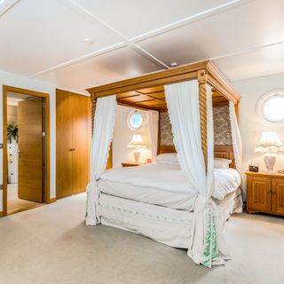 penelope master bedroom with wooden door and bed
