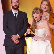 Taylor Swift accepts the Album Of The Year award for "Midnights" on stage with Celine Dion at the 66th Annual GRAMMY Awards held at Crypto.com Arena on February 4, 2024 in Los Angeles, California