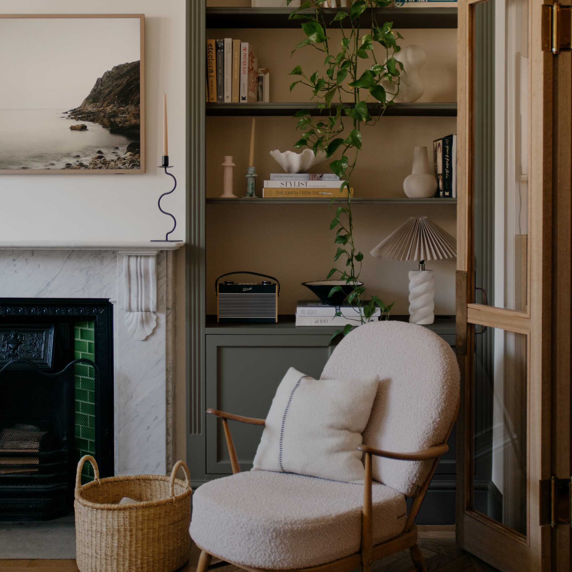 A living room with a built-in alcove bookcase painted in COAT's Retrograde