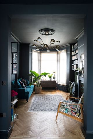 Living room painted in Farrow & Ball Downpipe with dark walls and ceiling