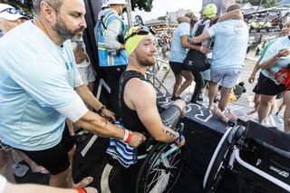 Smiling, Billy Monger in his wheelchair preparing to enter the swimming section of the Ironman.