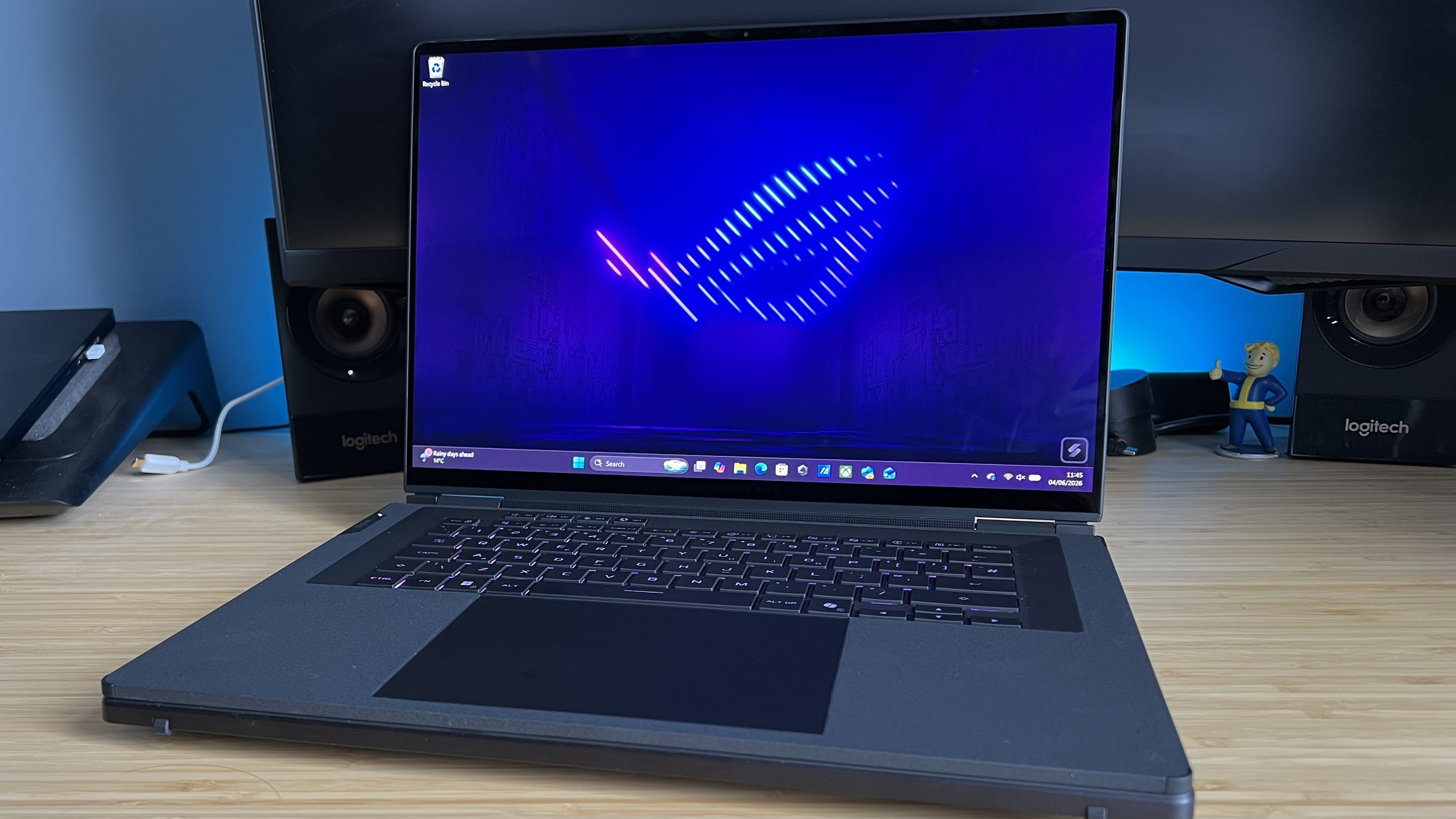 Asus ROG Zephyrus Duo gaming laptop in traditional clamshell use mode on a wooden desk