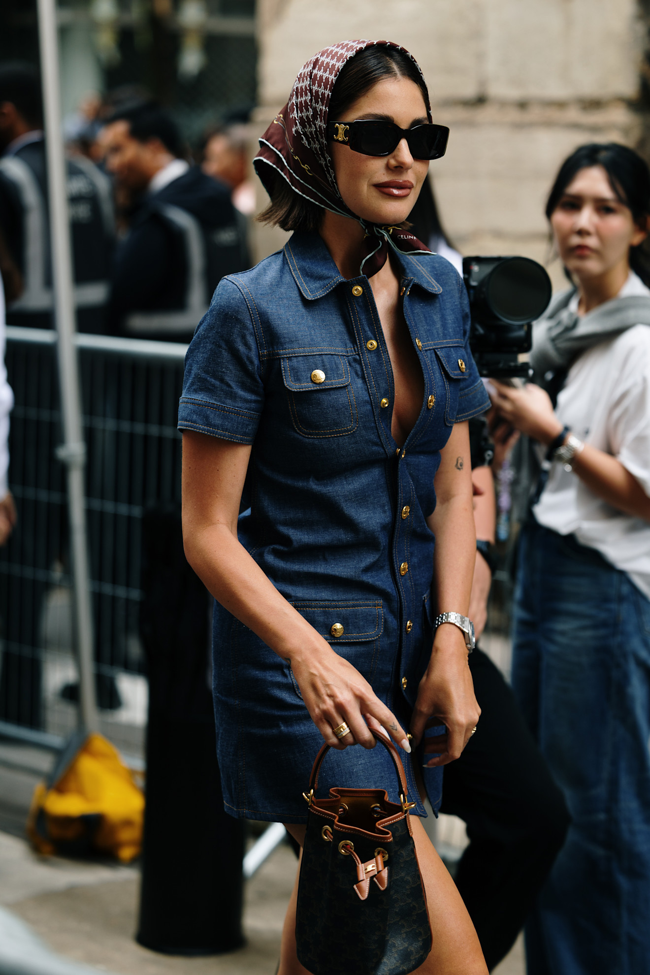 woman wearing a scarf and a denim dress.
