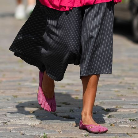 a guest at Copenhagen Fashion Week wearing vibram fivefingers shoes