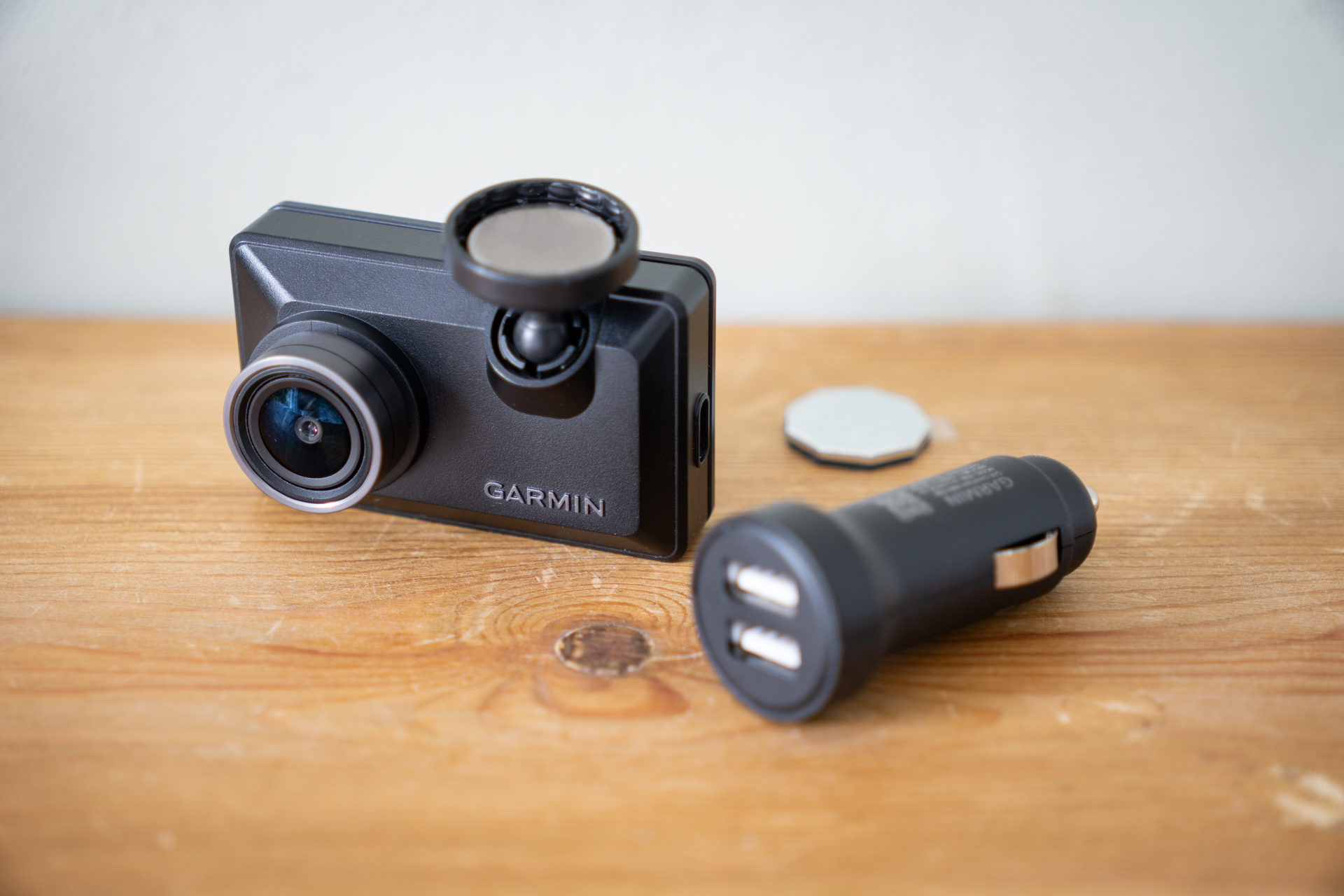 Garmin Dash Cam X210 on a wooden surface