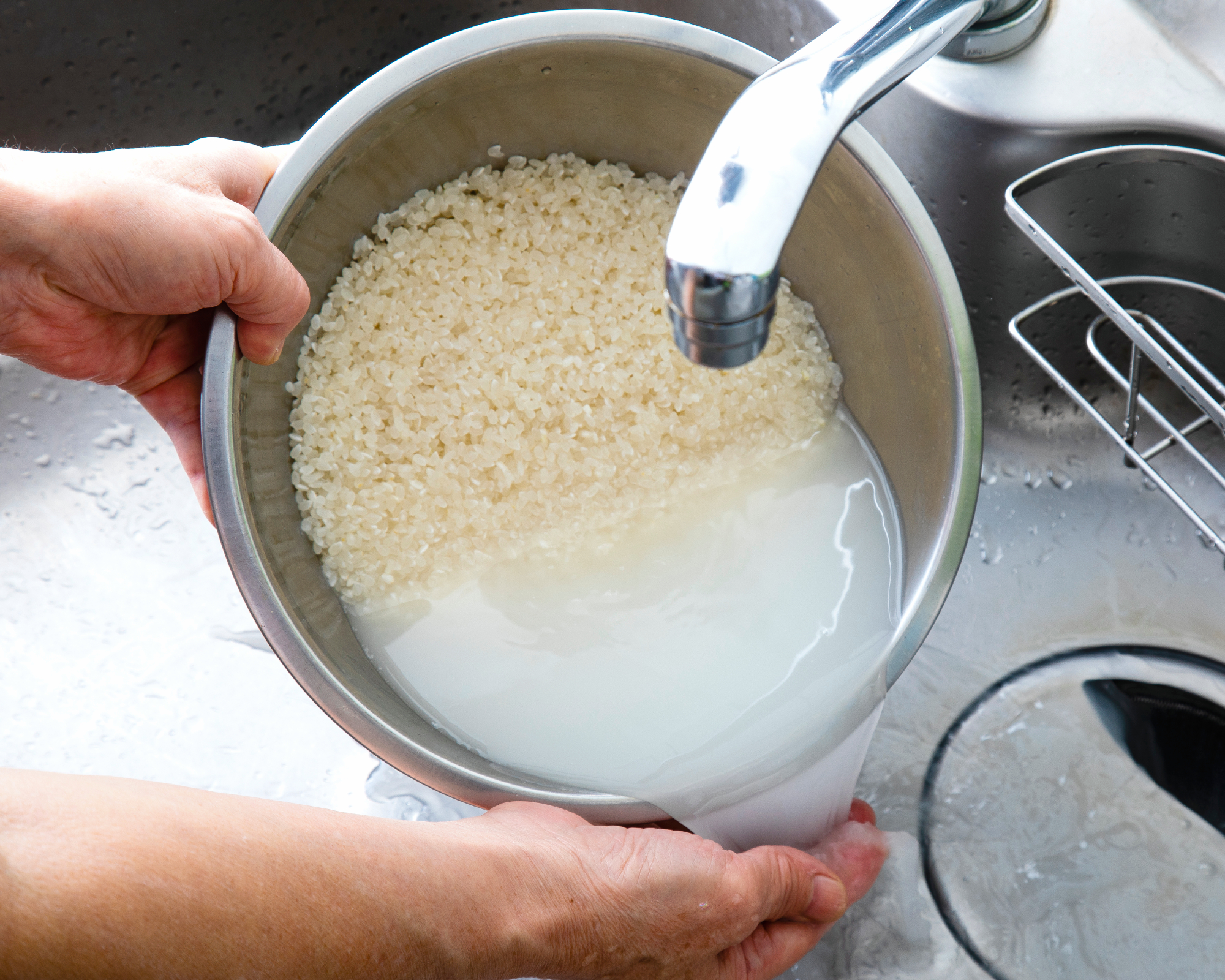 Person pouring off rice water