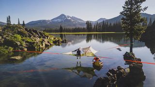 Tensile tent suspended above the water