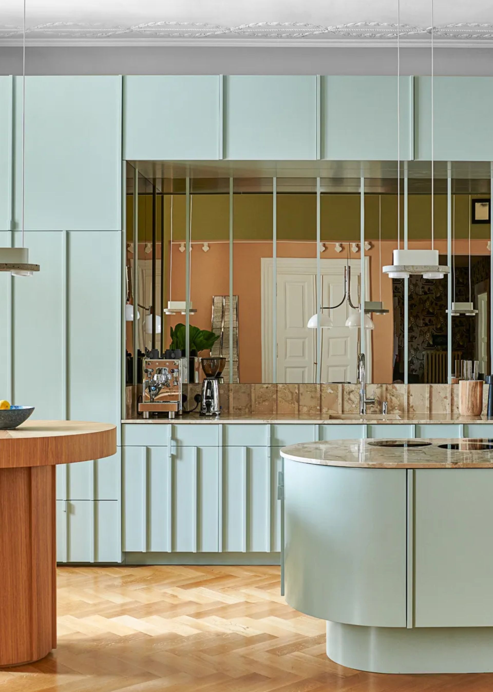 a light blue kitchen with a mirrored backdrop