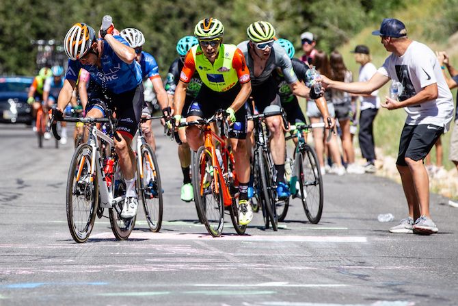 Fans hand up water on the steep climb into Wolf Creek Ranch on stage 6 of the 2019 Tour of Utah