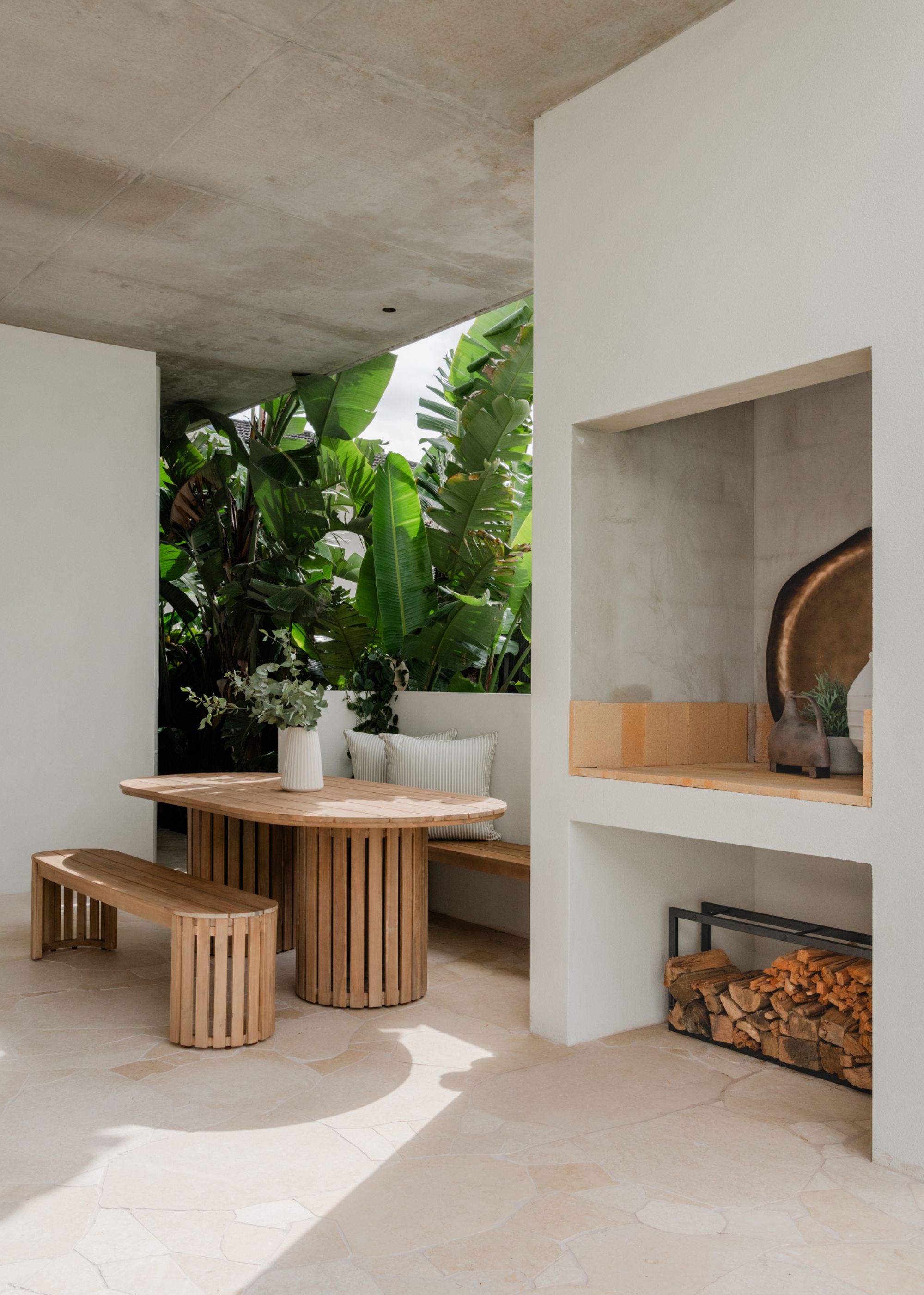 An outdoor dining room with wood dining table and bench