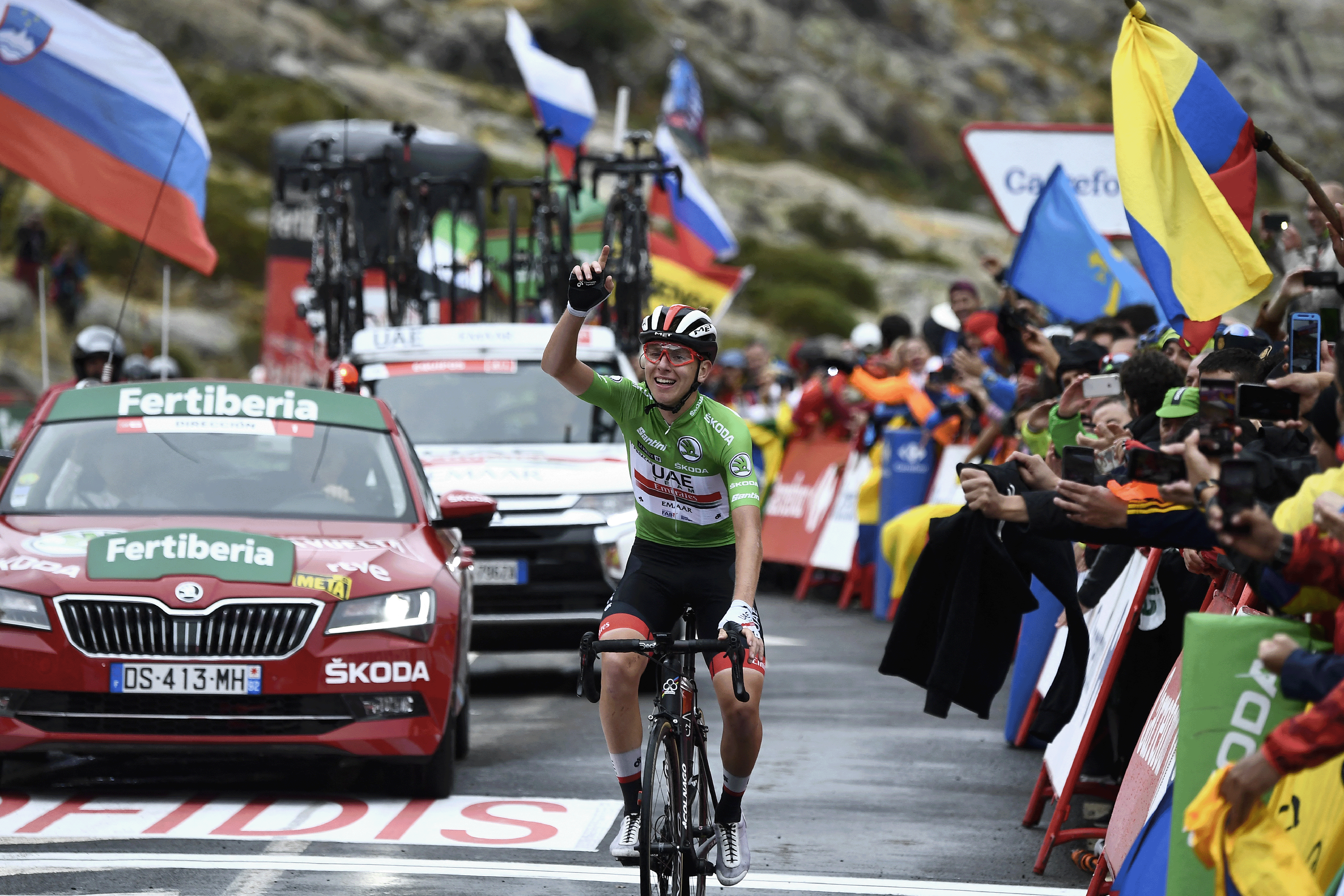 UAE Team Emirates-XRG rider Slovenia's Tadej Pogacar celebrates as he crosses the finish line of the 20th stage of the 2019 La Vuelta cycling Tour of Spain