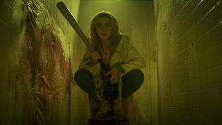 Jamie Hughes hides in a bathroom stall in Prime Video horror movie Totally Killer