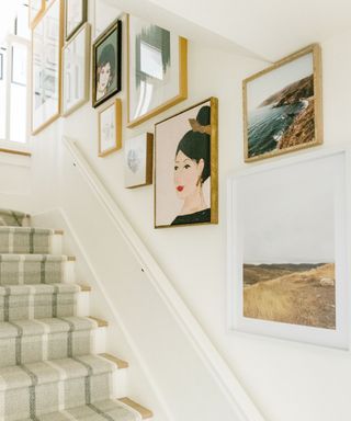 Stripped staircase carpet, framed pictures