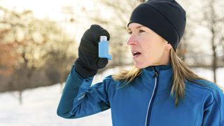 female runner with asthma inhaler