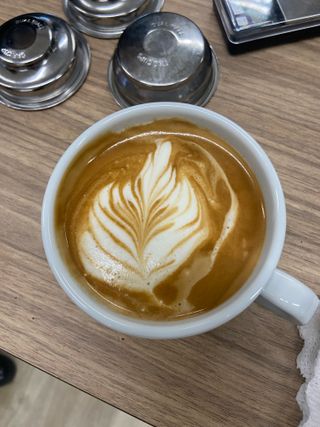 an oat milk flat white made on the smeg mini pro espresso machine