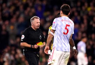 Manchester United captain Harry Maguire is sent off by referee Jonathan Moss