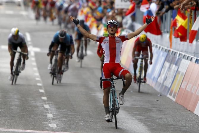 Kwiatkowski celebrates as the other riders fight for the medals