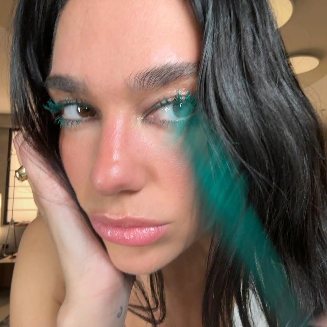 An image posted to Dua Lipa's Instagram account of the singer applying and wearing wearing turquoise mascara.