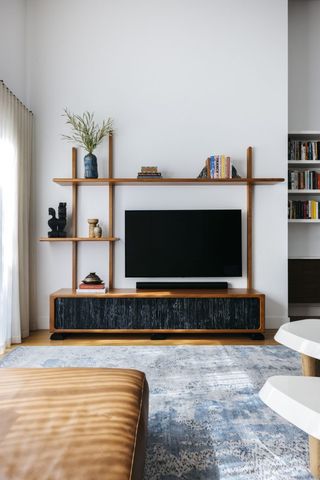 Modern living room with wooden TV console with shelving