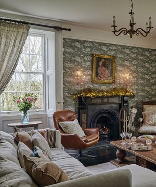 living room in a Victorian home decorated with a christmas garland on the mantlepiece