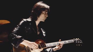 British guitarist Steve Hackett of rock group Genesis performing with a Gibson Les Paul Goldtop, 1974
