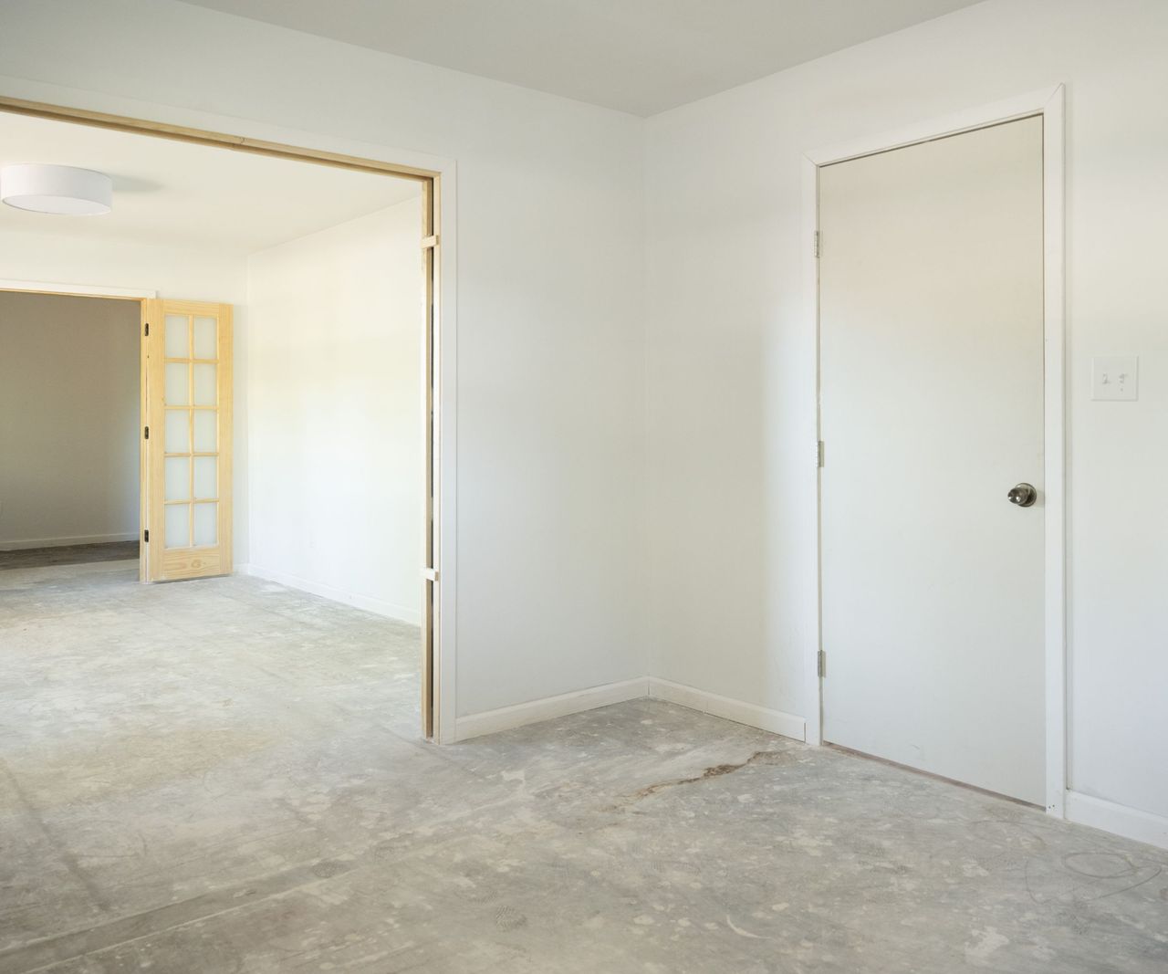 Empty room with white walls, carpet and doorway