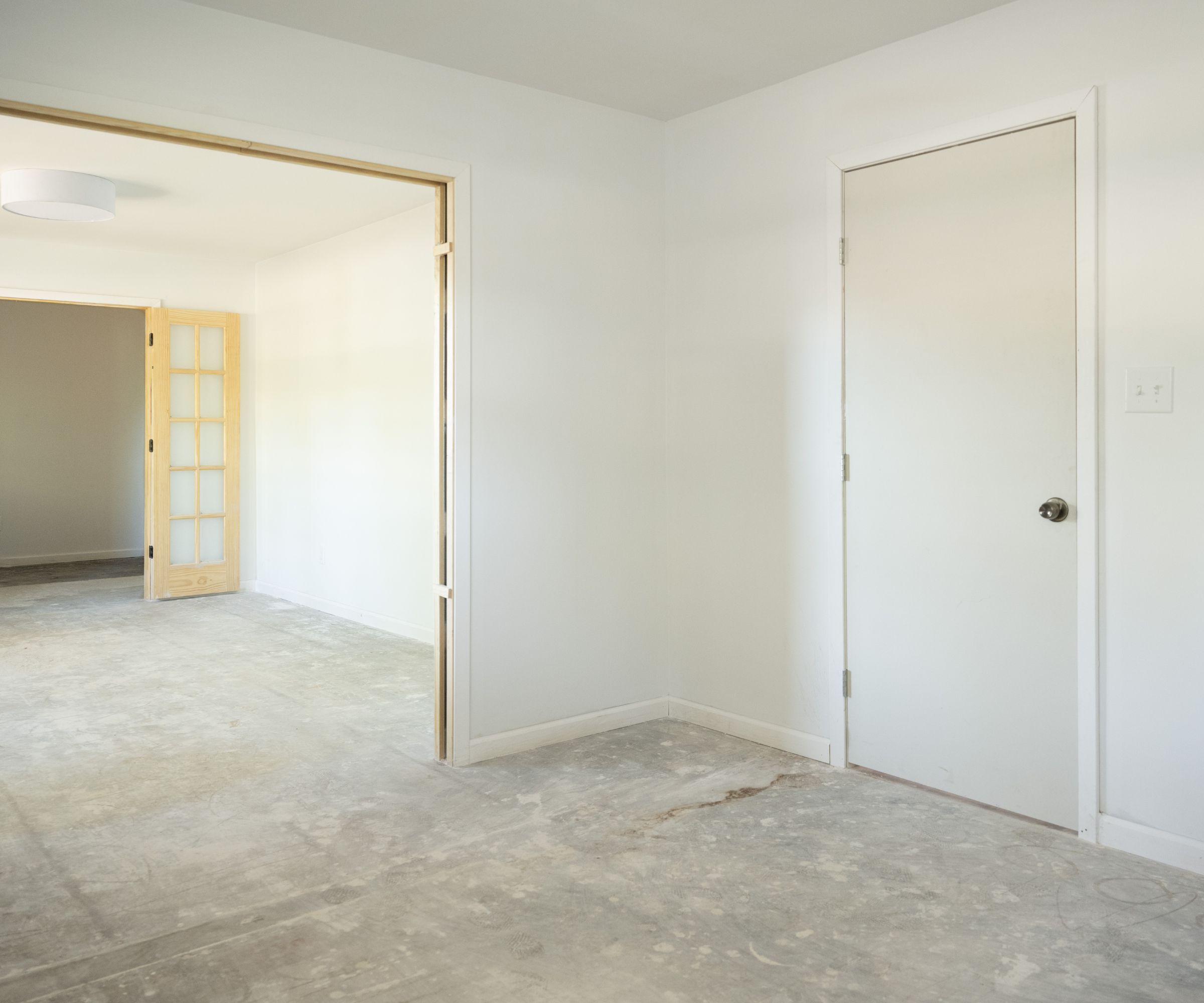 Empty room with white walls, carpet and doorway